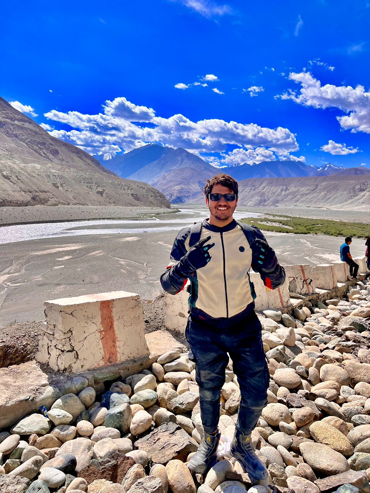 Happy traveler enjoying a Ladakh tour with scenic mountain views